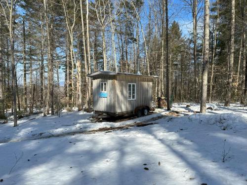 a small shack in the woods in the snow at Lodging at The Hummingbird Center in Rumney