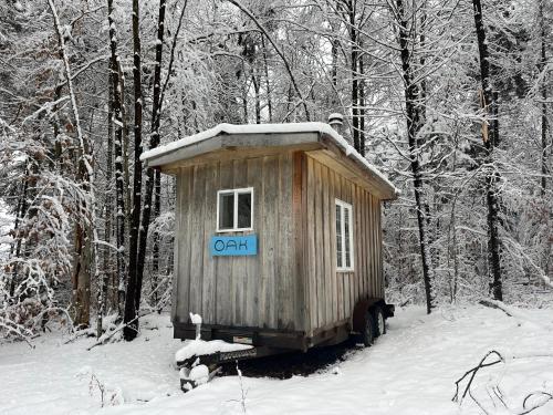 a small shack in the snow in the woods at Lodging at The Hummingbird Center in Rumney