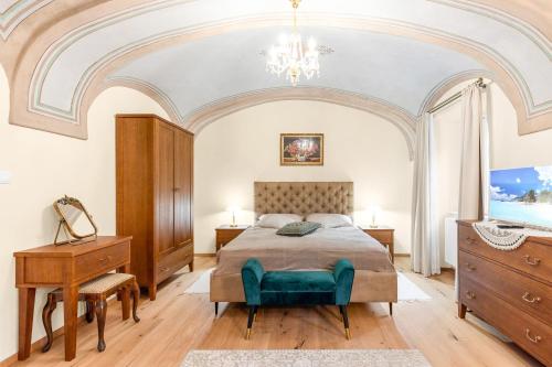 a bedroom with a bed and a chandelier at Apartmány sv. Floriána in Banská Štiavnica