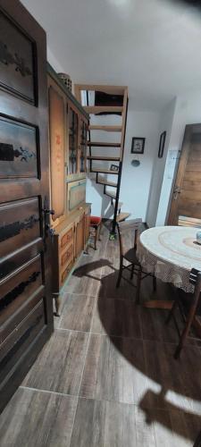 a room with a table and chairs and a staircase at Golemi kamik Pirot Vlasi 2 in Pirot