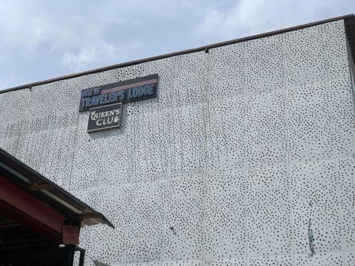 a white building with a sign on the side of it at New Travellers Lodge Sangotedo Lagos in Lekki