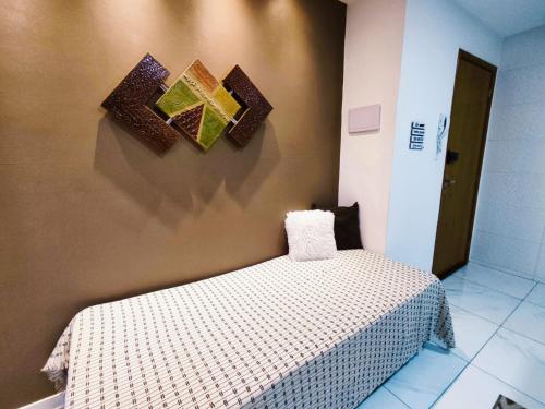 Un pat sau paturi într-o cameră la Studio luxuoso a 700 metros da praia. Vila Velha ES