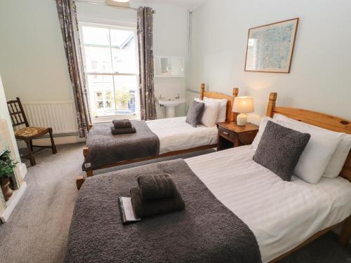 a hotel room with two beds and a window at Pelham House in Keswick