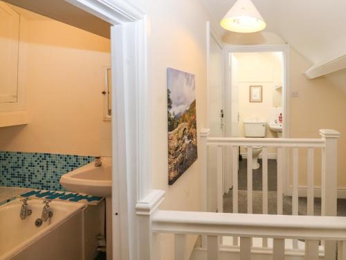 a bathroom with a tub and a sink and a bath tub at Pelham House in Keswick