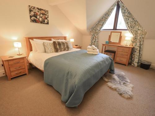 a bedroom with a large bed and a window at Beechside in Ambleside