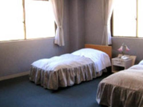 a bedroom with two beds and a window at Shoji Mount Hotel - Vacation STAY 78001v in Narusawa