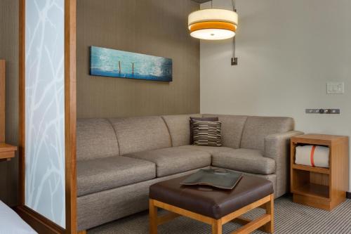 a living room with a couch, coffee table and a lamp at Hyatt Place Chicago/Downtown - The Loop in Chicago