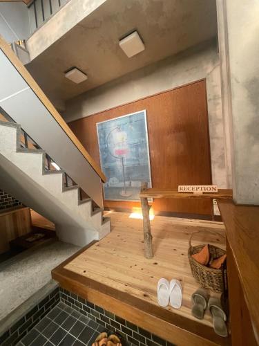 a room with a staircase with a bench and two shoes at art village - Vacation STAY 16315v in Awa