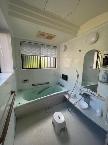 a bathroom with a tub and a toilet and a sink at art village - Vacation STAY 16315v in Awa