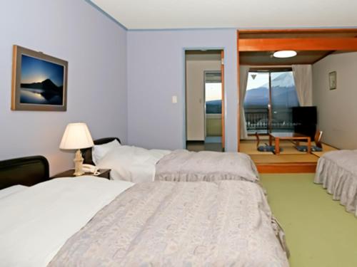 Rúm í herbergi á Shoji Mount Hotel - Vacation STAY 82979v