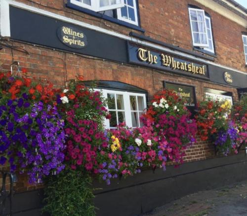 a bunch of flowers on the side of a building at The Wheatsheaf in Bramley