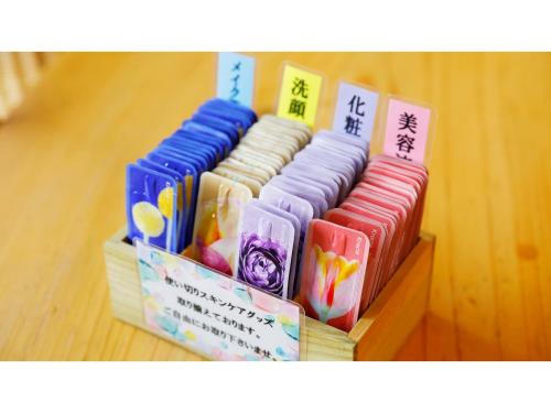 a group ofcolored bangles sitting on a wooden shelf at Mikuma Hotel - Vacation STAY 63475v in Hita