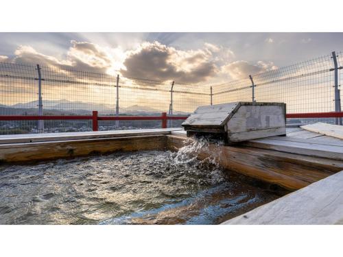 a body of water with a fence and water fountain at Mikuma Hotel - Vacation STAY 63469v in Hita