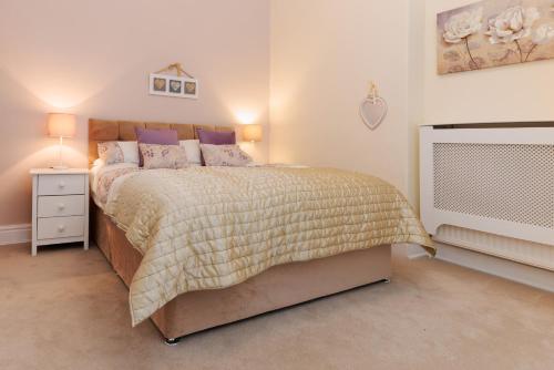 a bedroom with a large bed and a tv at The Spires in Scarborough