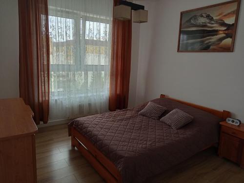 a bedroom with a bed and a window at Apartament mieszkanie dostęp zdalny bez potrzeby odbioru kluczy in Giżycko