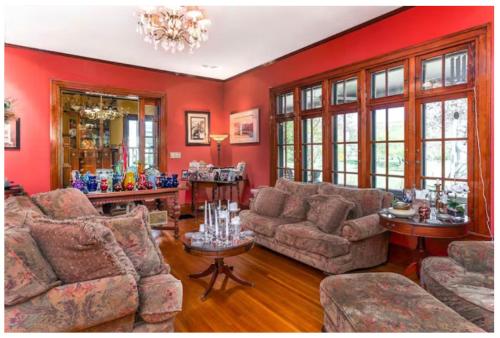 a living room with red walls and couches at Mike & Allen's Place on the Park_2 in Columbus
