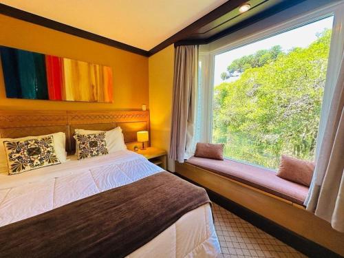 Giường trong phòng chung tại Studio Super Luxo Laje de Pedra MV (3019)