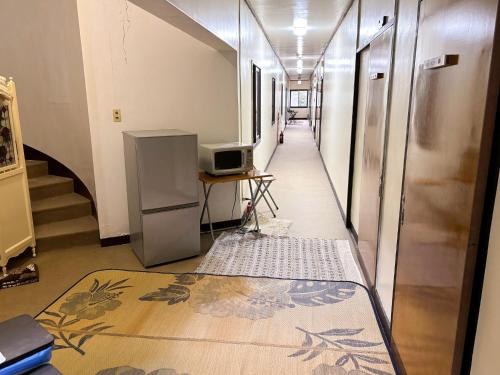 a hallway with a television and a desk in a building at Eco Hotel Yunokosou - Vacation STAY 99597v in Minamata