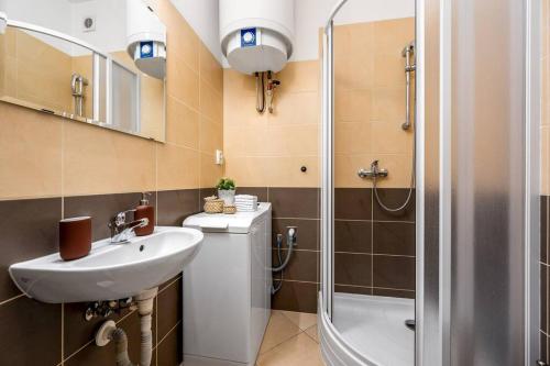 a bathroom with a sink and a shower at Art Deco Suite in Prague