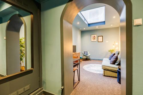 a hallway with a skylight and a living room at SeventyFive in Amsterdam