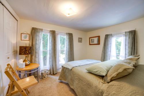 a bedroom with a bed and a table and windows at Fire Pit, BBQ and Yard Family Home in Adrian in Adrian