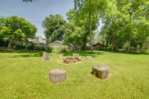 a fire pit in a yard with tree stumps at Fire Pit, BBQ and Yard Family Home in Adrian in Adrian