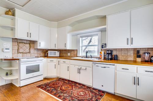 a kitchen with white cabinets and a rug at Large Group Getaway in Georgetown with Private Pool! in Georgetown