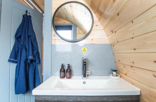 a bathroom with a sink and a mirror at Loch View Luxury Pod in Connel
