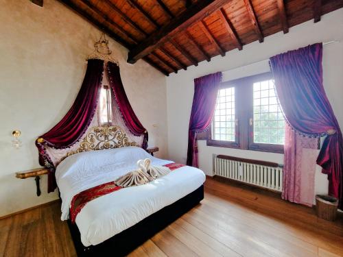 a bedroom with a large bed with a canopy at Villetta dei Fagiani - B&B in Montauto