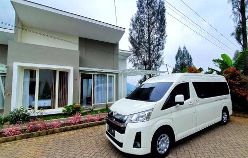 a white van parked in front of a house at Bromo Villass in Ngadisari