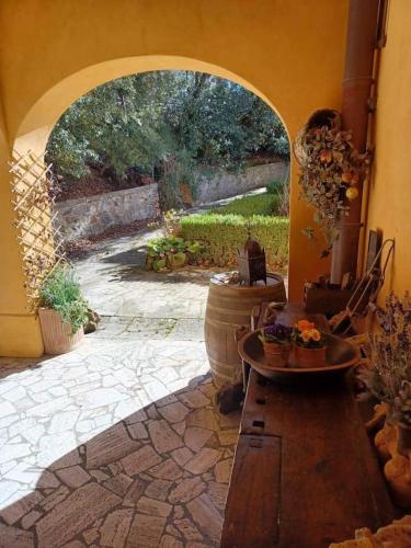 an archway in a room with a stone patio at Casa Asilo La Foce, Val d' Orcia, Pienza. in Pienza