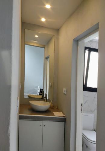 a bathroom with a sink and a large mirror at Morada del Mar in Mar de Cobo