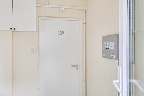 a pair of white doors in a room at Oxted High St in Titsey