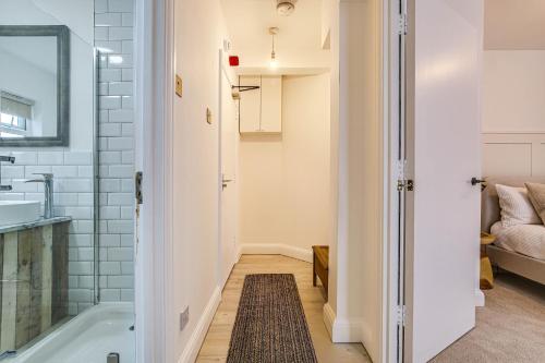 a bathroom with a tub and a sink at Oxted High St in Titsey