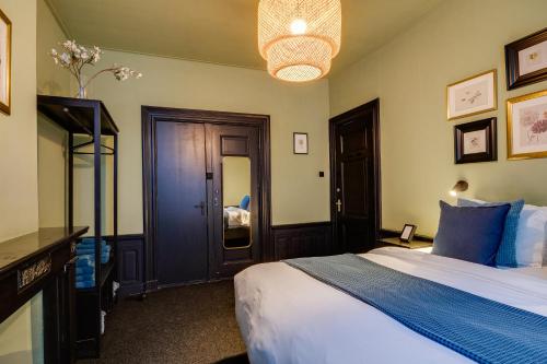 a bedroom with a large bed and a mirror at SeventyFive in Amsterdam