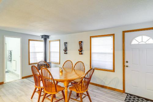 a dining room with a wooden table and chairs at Cozy Norfork Home by White River Hike and Fish in Norfork