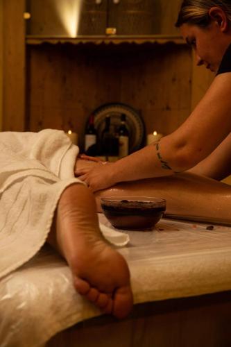 a woman in a towel sitting on a counter at Hotel Galli in Livigno