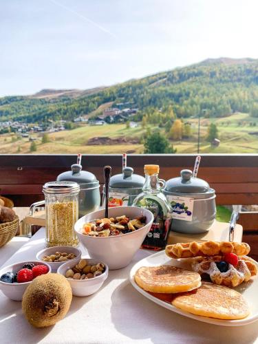 a table with a plate of food on a table at Hotel Galli in Livigno