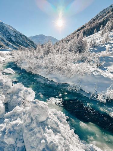 a river covered in snow and ice at Hotel Galli in Livigno