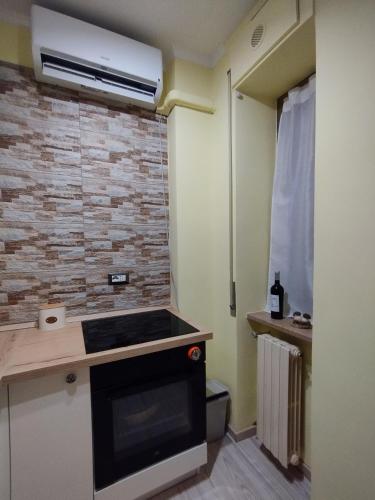 a kitchen with a stove and a brick wall at Casa Ciano in Foggia