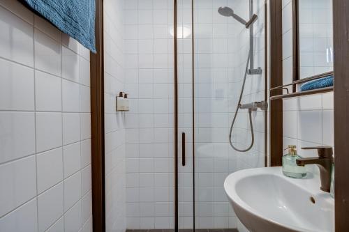 a bathroom with a shower and a sink at SeventyFive in Amsterdam