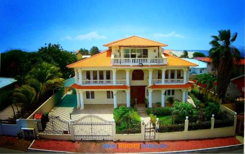 a large white house with an orange roof at Reverie in Willemstad