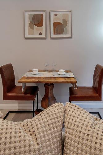 a table with two chairs and a table with a couch at The Bridge Guesthouse in Maguires Bridge