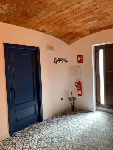 a blue door in a room with a wall at La Casa de La Lala in Olivenza