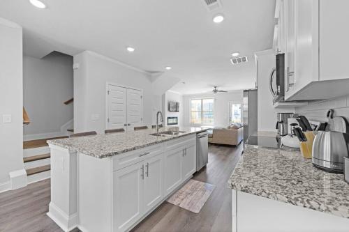 a kitchen with white cabinets and granite counter tops at Luxury 2 bedrooms, 2.5 baths in Lawrenceville