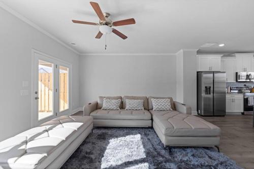 a living room with a couch and a ceiling fan at Luxury 2 bedrooms, 2.5 baths in Lawrenceville