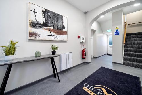 an office hallway with a desk and a staircase at The Bridge Guesthouse in Maguires Bridge