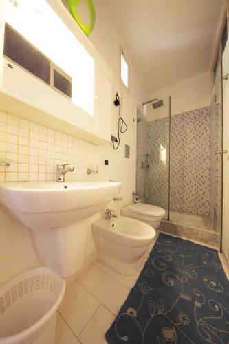 a bathroom with a sink and a toilet and a shower at Gioeni 23 in Cefalù