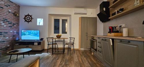 a kitchen with a small table with a computer on it at Apartman Pontica in Kotor