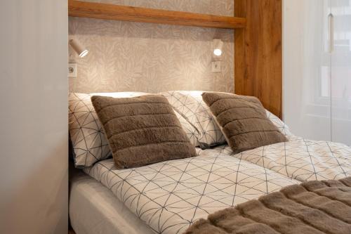 ein Bett mit zwei Kissen darüber in der Unterkunft Ekskluzywny apartament + garaż in Krakau